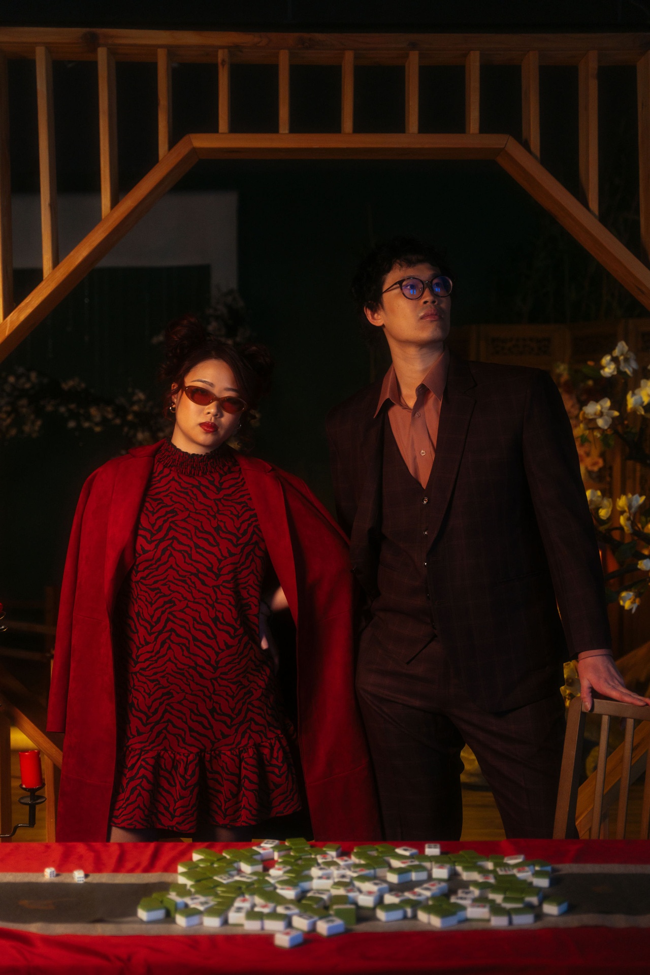 Teck Yan and Julie cheek to cheek, laughing in warm tungsten light